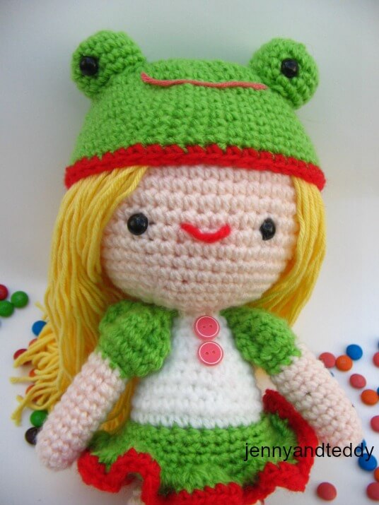 Kelly crochet doll in a frog hat amigurumi crochet pattern.