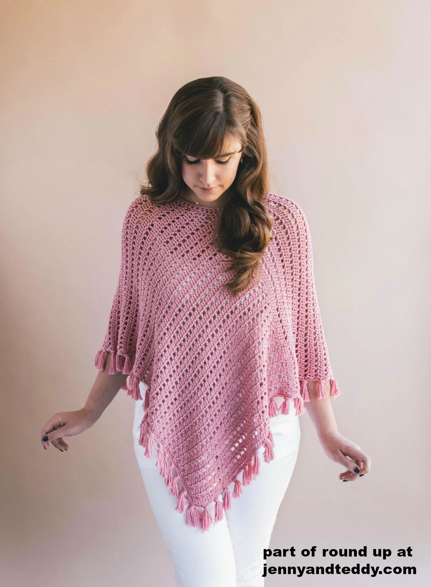 fringe poncho in pink color.